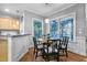 Inviting dining area with wood table, chairs, pendant lighting, and views of the porch at 908 Town Side Dr, Apex, NC 27502