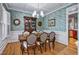 Formal dining room with decorative wallpaper, hardwood floors, and traditional furnishings at 908 Town Side Dr, Apex, NC 27502