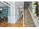 Elegant foyer with hardwood floors, decorative wainscoting, and a staircase at 908 Town Side Dr, Apex, NC 27502
