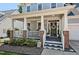 Inviting front porch with brick accents, white railings, and a decorative wreath on the front door at 908 Town Side Dr, Apex, NC 27502