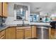 Modern kitchen featuring stainless steel appliances and light wood cabinets at 908 Town Side Dr, Apex, NC 27502