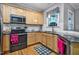 Well-equipped kitchen featuring stainless steel appliances and light wood cabinets at 908 Town Side Dr, Apex, NC 27502