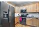 Well-equipped kitchen featuring stainless steel appliances and light wood cabinets at 908 Town Side Dr, Apex, NC 27502