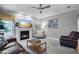 Cozy living room with a fireplace, comfortable seating, and natural light at 908 Town Side Dr, Apex, NC 27502