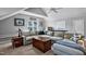 Spacious living room with large sectional sofa, ceiling fan, and natural light from the window at 908 Town Side Dr, Apex, NC 27502