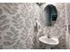 Elegant powder room featuring stylish wallpaper and a pedestal sink at 908 Town Side Dr, Apex, NC 27502