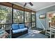 Inviting screened porch with wicker sofa, ceiling fan, and exterior door with view of backyard at 908 Town Side Dr, Apex, NC 27502
