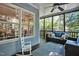 Cozy screened porch with ceiling fan and outdoor seating offering a pleasant view of the yard at 908 Town Side Dr, Apex, NC 27502