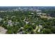 Lush, green aerial view of the community with the city skyline in the distance, highlighting its location at 911 Washington St # 304, Raleigh, NC 27605