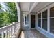Private balcony with wood flooring, white railing, and windows providing natural light to the interior space at 911 Washington St # 304, Raleigh, NC 27605