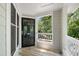 Open balcony featuring wood floors, gray walls, and white railings overlooking backyard greenery at 911 Washington St # 304, Raleigh, NC 27605