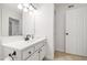 Well-lit bathroom featuring a vanity sink, and white cabinets at 911 Washington St # 304, Raleigh, NC 27605