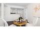 Light dining room with hardwood floors, white walls, and view of open kitchen at 911 Washington St # 304, Raleigh, NC 27605