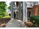 Condo entrance with concrete walkway, gray siding, white trim and unit mailbox at 911 Washington St # 304, Raleigh, NC 27605