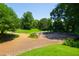 Manicured gardens with a stage area, paths, and lush greenery create a serene outdoor space for gatherings at 911 Washington St # 304, Raleigh, NC 27605