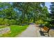 Tranquil garden path with benches, green grass, and lush trees, ideal for relaxing strolls at 911 Washington St # 304, Raleigh, NC 27605