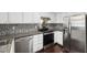Updated kitchen with stainless steel appliances, sleek countertops, and mosaic tile backsplash at 911 Washington St # 304, Raleigh, NC 27605