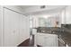 Open kitchen with stainless sink, granite counters and stainless dishwasher looking towards living room at 911 Washington St # 304, Raleigh, NC 27605