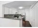 Bright kitchen features white cabinets, granite countertops, stainless steel appliances, and stylish backsplash at 911 Washington St # 304, Raleigh, NC 27605