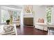 Bright living room featuring a decorative fireplace and large windows with natural light at 911 Washington St # 304, Raleigh, NC 27605