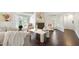 Sun-filled living room with hardwood floors, white sofas, and view of bay window seating area at 911 Washington St # 304, Raleigh, NC 27605