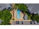Aerial view of a community pool featuring lounge chairs, lush greenery, and a parking lot at 911 Washington St # 304, Raleigh, NC 27605