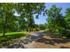 Scenic walking path surrounded by lush greenery and shade trees, perfect for a relaxing stroll in nature at 911 Washington St # 304, Raleigh, NC 27605