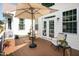 Inviting outdoor space on a back deck with a seating area and a large umbrella at 9136 Palm Bay Cir, Raleigh, NC 27617