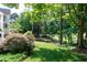 Lush backyard with mature trees, manicured lawn, and serene landscaping, creating a peaceful outdoor retreat at 9136 Palm Bay Cir, Raleigh, NC 27617