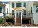 Outdoor deck and backyard with seating, plants and shade umbrella at 9136 Palm Bay Cir, Raleigh, NC 27617