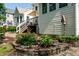 Beautiful landscaping surrounding the back of the house with a deck and awning at 9136 Palm Bay Cir, Raleigh, NC 27617