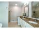 Bathroom with double sink vanity, granite countertops, decorative mirrors, and glass enclosed shower at 9136 Palm Bay Cir, Raleigh, NC 27617