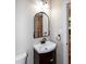 Elegant powder room featuring a stylish vanity, decorative mirror, and modern fixtures at 9136 Palm Bay Cir, Raleigh, NC 27617