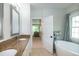 Bathroom with double vanity, granite countertops, soaking tub, and a glass enclosed shower at 9136 Palm Bay Cir, Raleigh, NC 27617