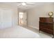 Cozy bedroom featuring a ceiling fan, closet, and an open doorway to a bright home interior at 9136 Palm Bay Cir, Raleigh, NC 27617