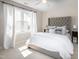 Bright bedroom with large window, curtains, and king sized bed at 9136 Palm Bay Cir, Raleigh, NC 27617