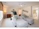 Bright bedroom features neutral walls, ceiling fan and a seating area at 9136 Palm Bay Cir, Raleigh, NC 27617