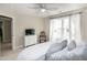 Bright bedroom features neutral walls, curtains, dresser and TV at 9136 Palm Bay Cir, Raleigh, NC 27617