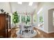 Bright breakfast area with skylights, chandelier, hardwood floors, and glass top table at 9136 Palm Bay Cir, Raleigh, NC 27617
