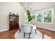 Dining area featuring a wood china cabinet, round table, and large windows for natural light at 9136 Palm Bay Cir, Raleigh, NC 27617
