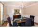 Formal dining room features a chandelier, hardwood floors, and classic decor for elegant meals at 9136 Palm Bay Cir, Raleigh, NC 27617