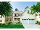 Charming two-story home with a manicured lawn and a two-car garage at 9136 Palm Bay Cir, Raleigh, NC 27617