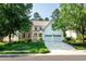 Charming two-story home with a well-manicured lawn, stone accents, and a two-car garage, showcasing curb appeal at 9136 Palm Bay Cir, Raleigh, NC 27617
