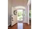 Inviting foyer with hardwood floors and front door view to the yard at 9136 Palm Bay Cir, Raleigh, NC 27617