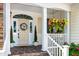Welcoming front porch adorned with hanging flower baskets, planters, and a decorative wreath at 9136 Palm Bay Cir, Raleigh, NC 27617