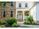 Charming front porch with stone accents, decorative flowers, and a welcoming entrance, enhancing curb appeal at 9136 Palm Bay Cir, Raleigh, NC 27617