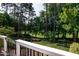 Scenic view of a lush green golf course and trees from a backyard deck at 9136 Palm Bay Cir, Raleigh, NC 27617