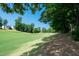 Scenic view of the expansive golf course, surrounded by lush greenery and mature trees, perfect for outdoor recreation at 9136 Palm Bay Cir, Raleigh, NC 27617
