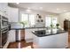 Modern kitchen with white cabinets, stainless steel appliances, and granite countertops offers a sleek cooking space at 9136 Palm Bay Cir, Raleigh, NC 27617
