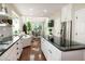 Bright, open kitchen featuring white cabinets, stainless steel appliances, and hardwood floors at 9136 Palm Bay Cir, Raleigh, NC 27617